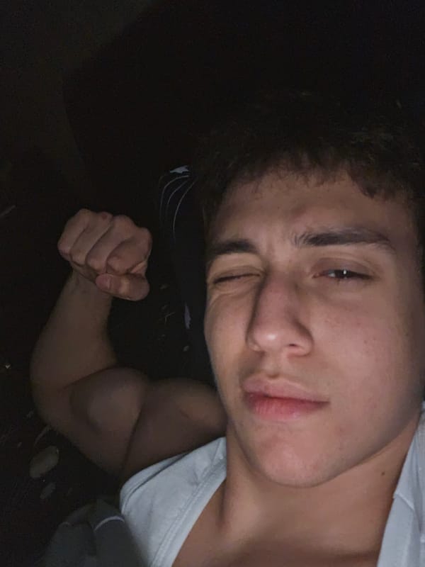 Young man takes playful flexing selfie in Yerevan