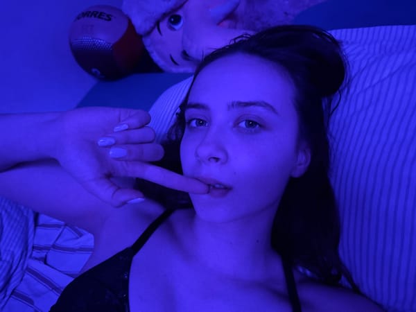 Woman photographed indoors under blue lighting in Prikamsky, Russia