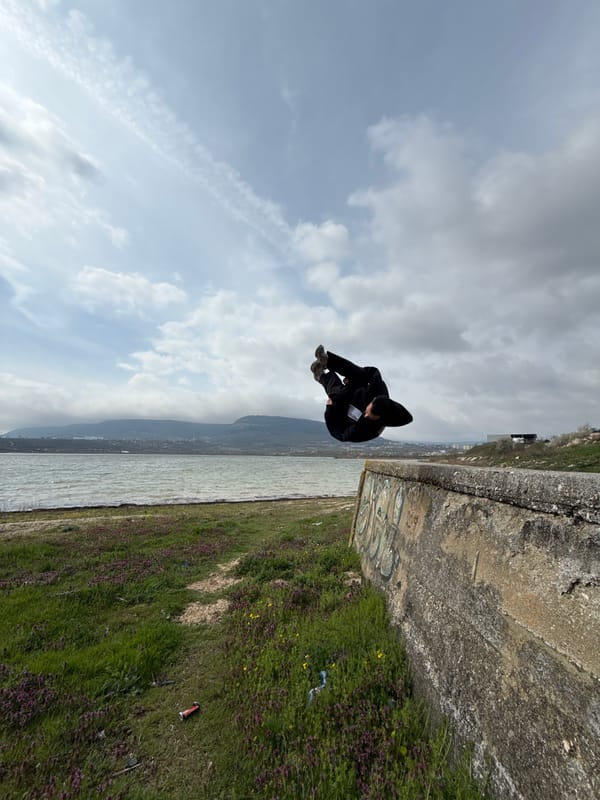Person performs acrobatics at Bulgarian waterfront during afternoon outing