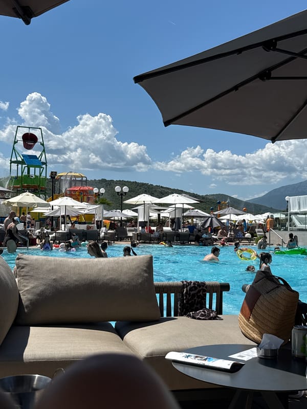 Poolside lunch gathering with pizza and drinks captured