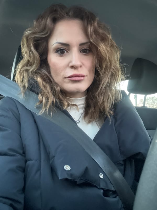 Woman in navy puffer jacket observed in London vehicle