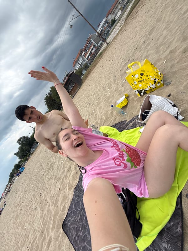 Beachgoers pose for selfies at Greek seaside resort