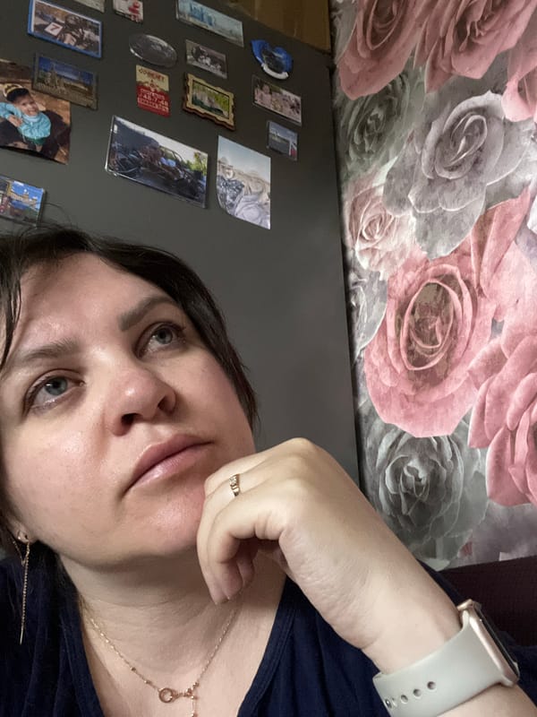 Woman photographed against decorated wall in Noviy, Russia