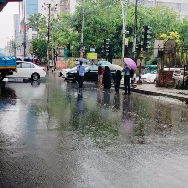 Rain-soaked Dhaka street creates reflective mirror of buildings