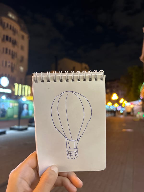 Night sketcher draws whimsical blue ink drawings on urban sidewalk