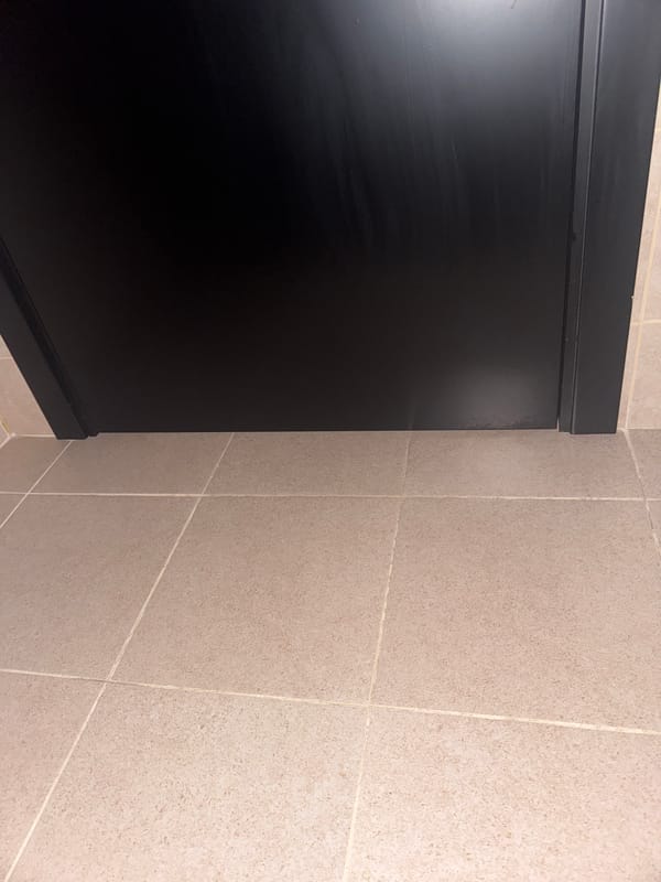 Bathroom interior with mop documented by witness
