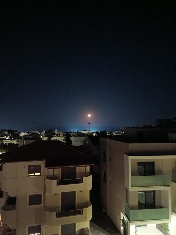 Full moon rises over Rhodes alongside a religious artifact