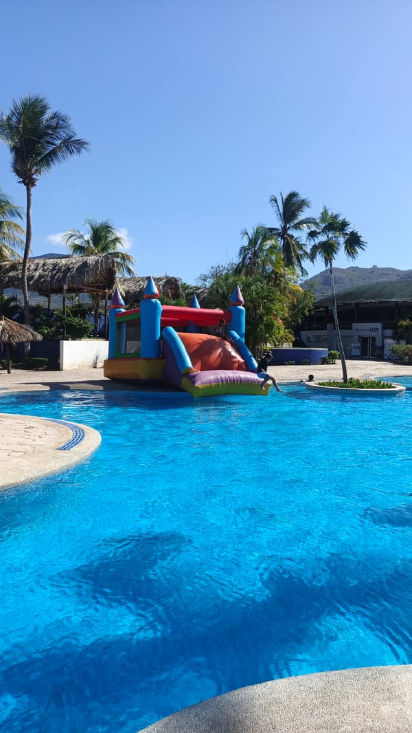 Resort scenes captured at Playa El Agua including costumed character