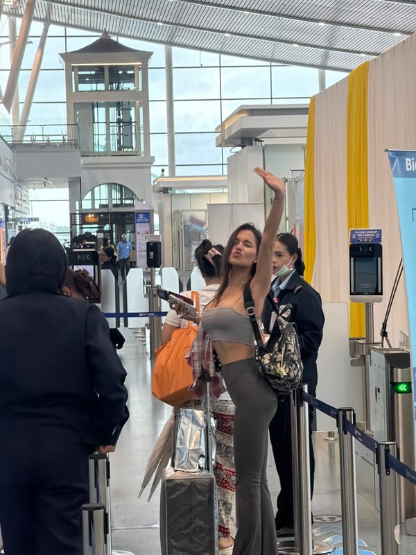 Woman gestures at automated border gate in Thailand airport