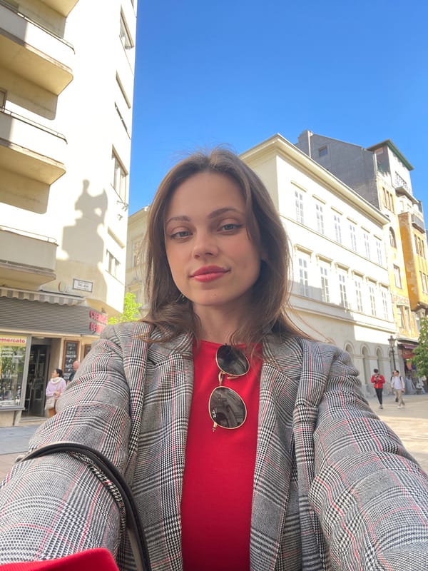 Woman takes selfies near anime shops in Budapest