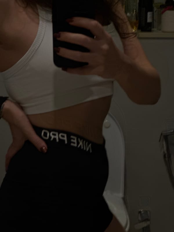 Person takes mirror selfie in athletic wear in Dubai
