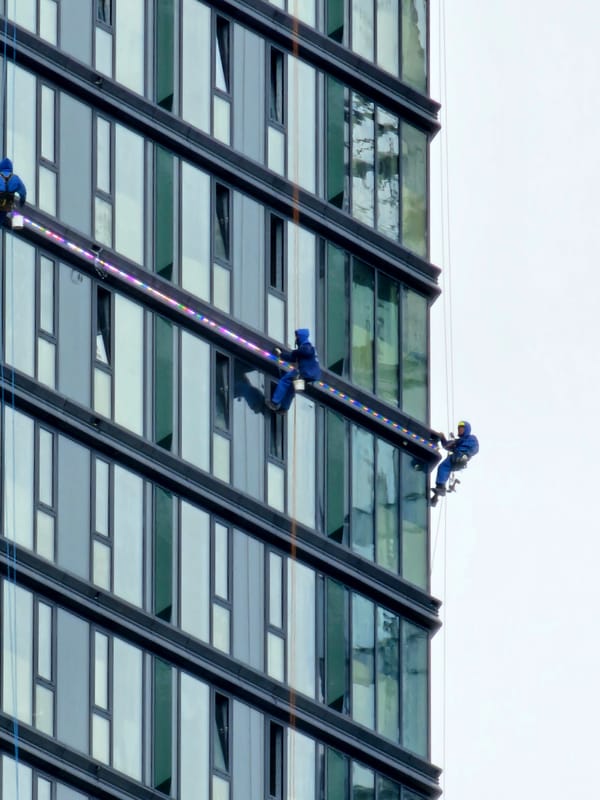 Window cleaning crew works high-rise glass facade in Moscow