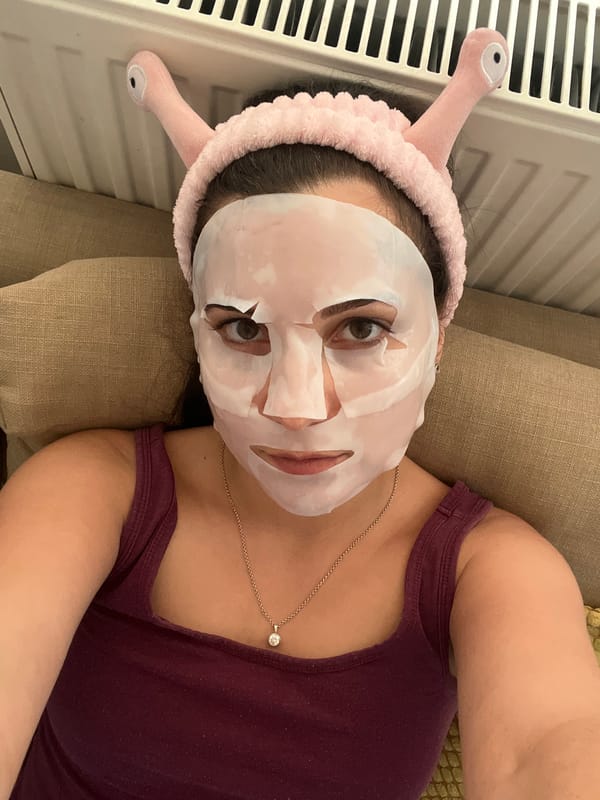 Sheet mask and jade roller skincare session at home