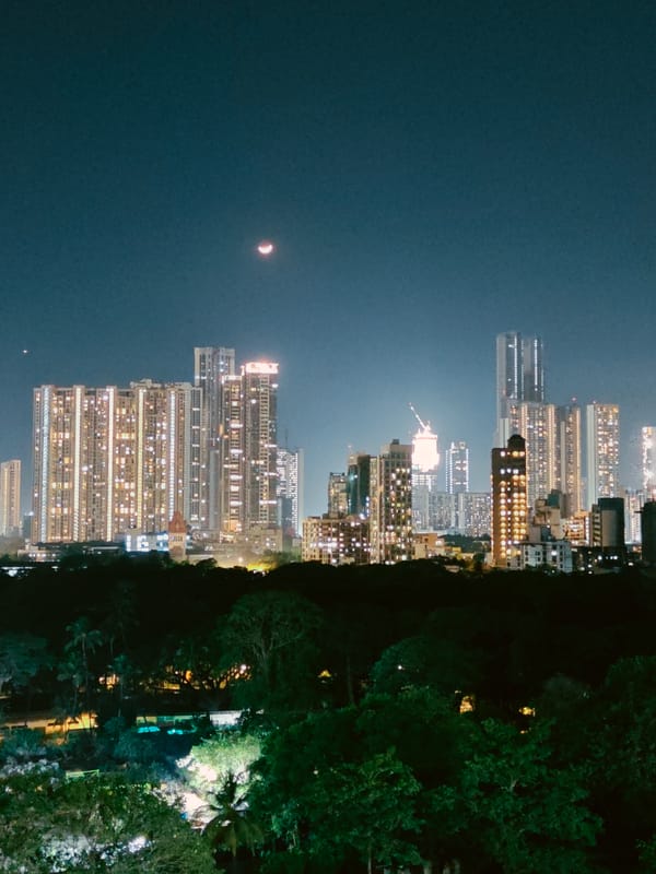 Father and child enjoy rooftop pool night in Mumbai