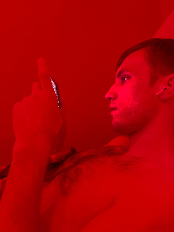 Man uses phone under red light in Kudrovo