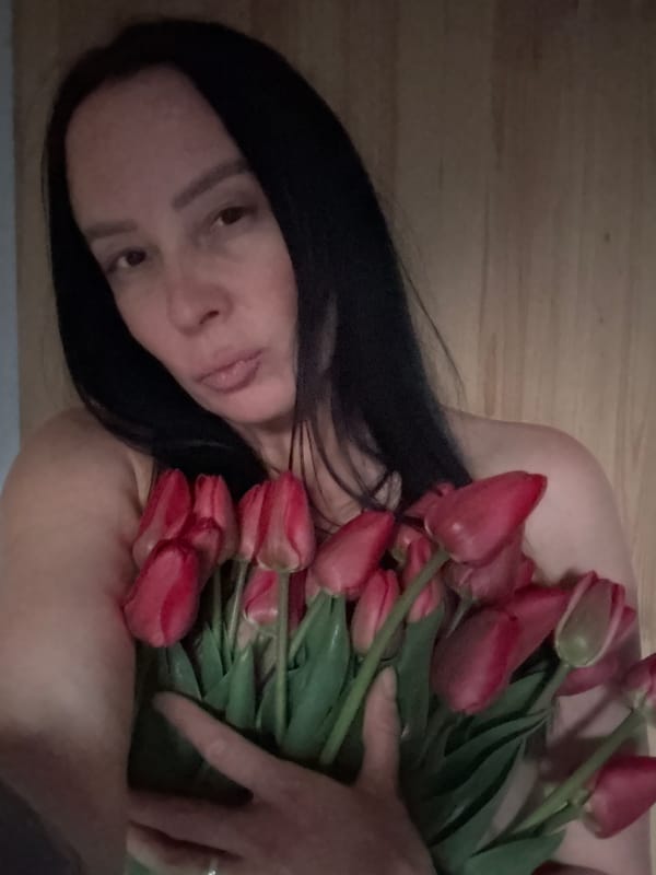 Woman poses with tulips across Chaikovsky locations during spring afternoon