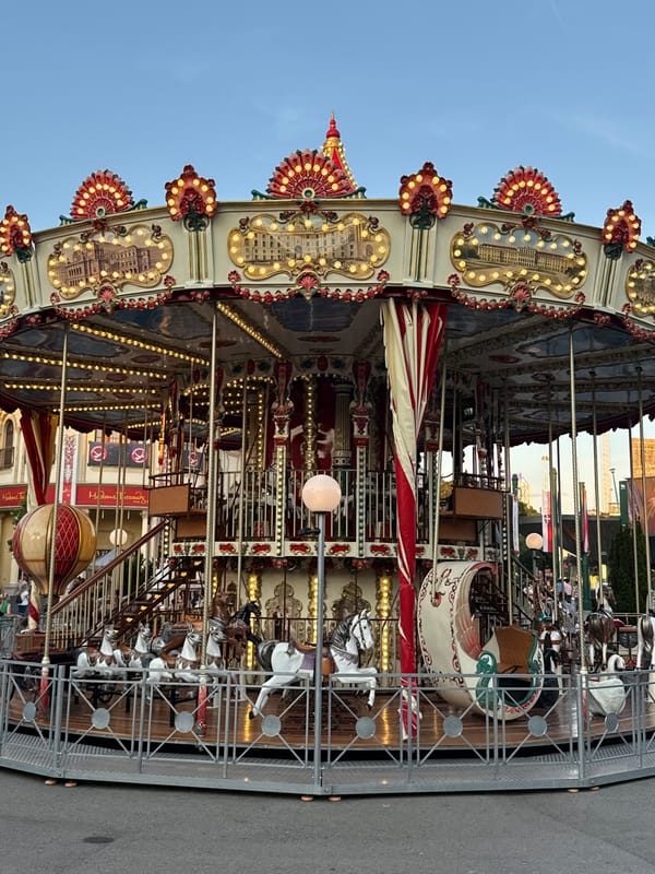 An evening at Vienna's Prater: Riesenrad, carousels, and swing rides.