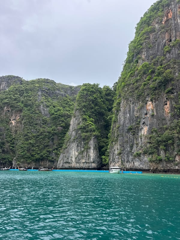 Dawn boat tours navigate Ao Nang's limestone cliffs