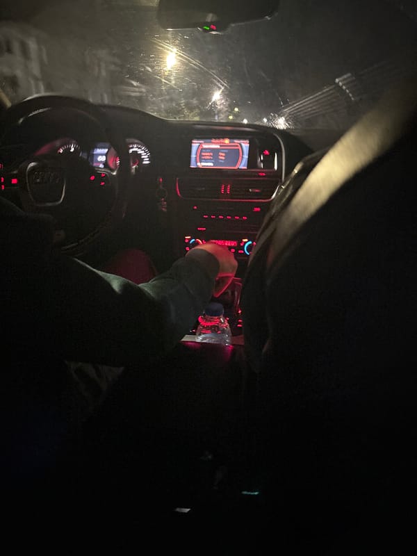 Driver adjusts console during rainy evening in Strazhitsa