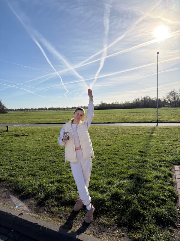 Woman stands in field holding object in Klarenbeek
