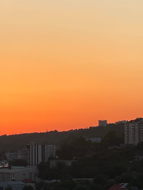 Chișinău sunset watched from above, city sprawling below