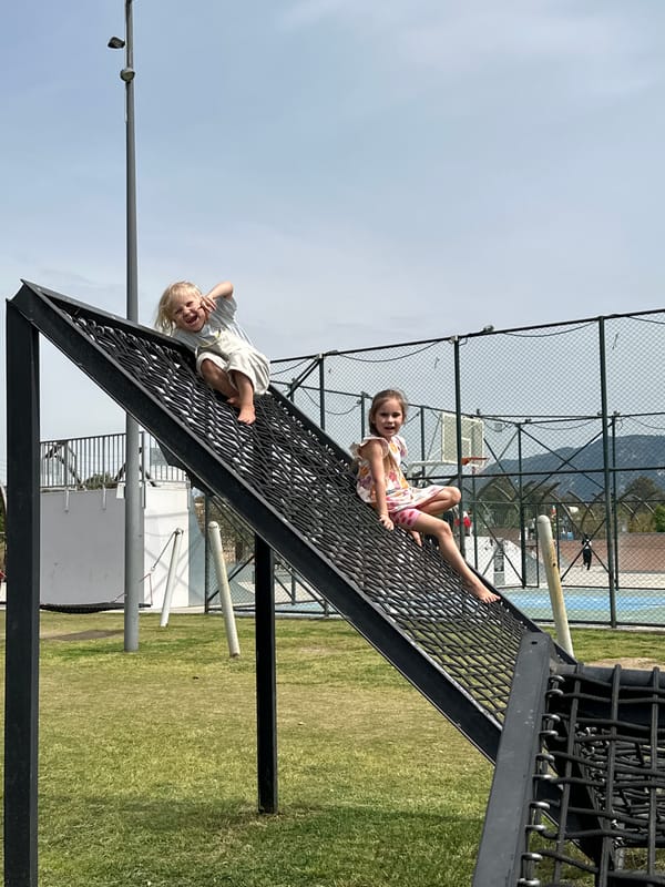 Children play on climbing nets, baby crawls in Fethiye