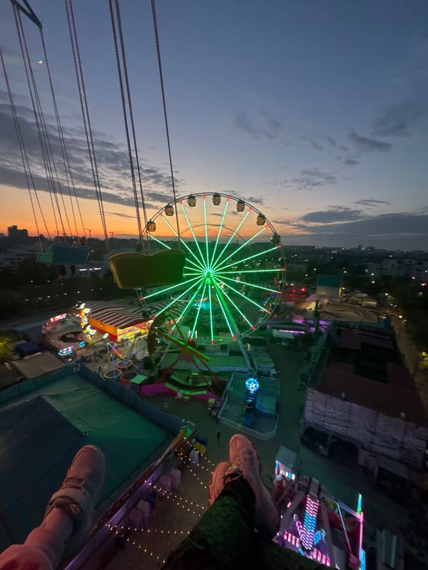 Evening carnival lights illuminate Yevpatoriya amusement park attractions