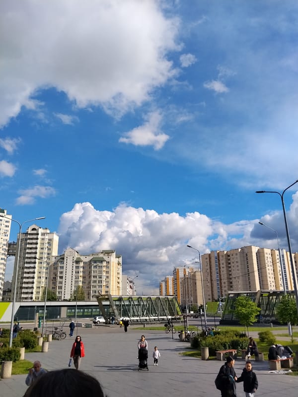 Urban residential buildings observed under cloudy blue sky