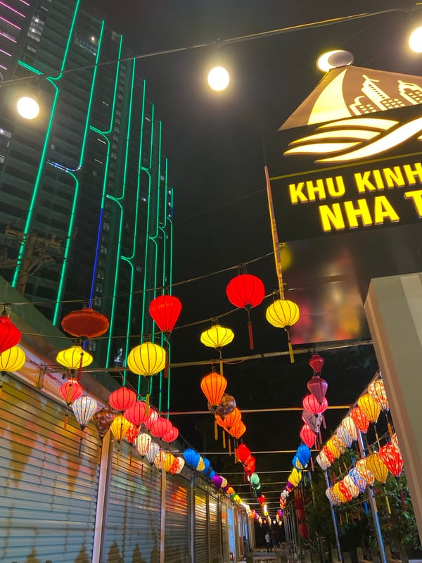 Nha Trang street glows with lanterns and green neon at night