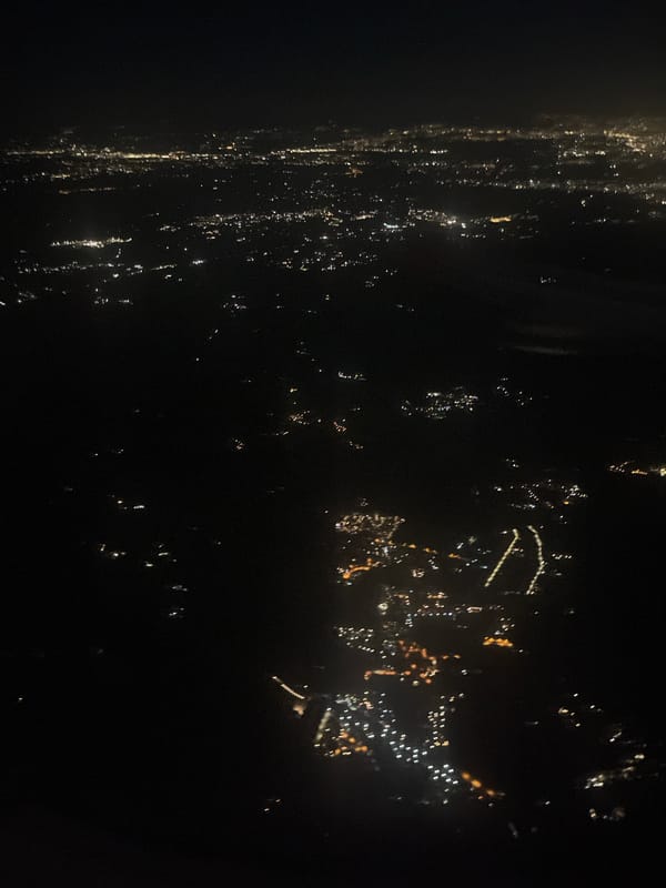 Nighttime aerial view captures city lights in Trevignano Romano
