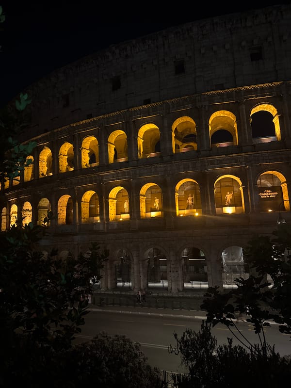 Couple captures nighttime selfie at illuminated Roman Colosseum