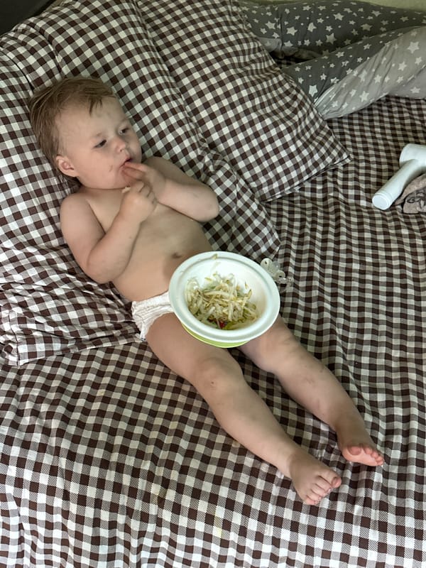 Baby feeds from bowl on stomach in Nizhny Novgorod