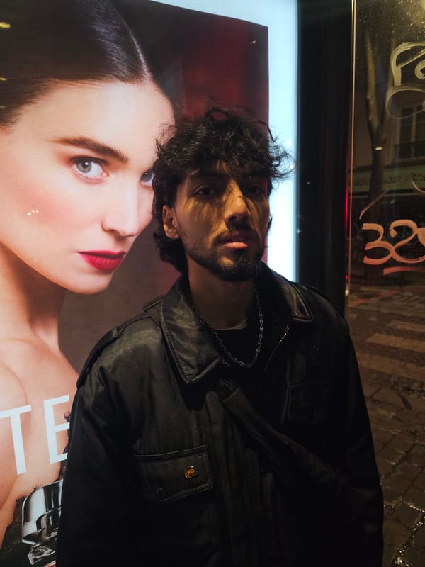 Man observed near illuminated display on Paris street late night