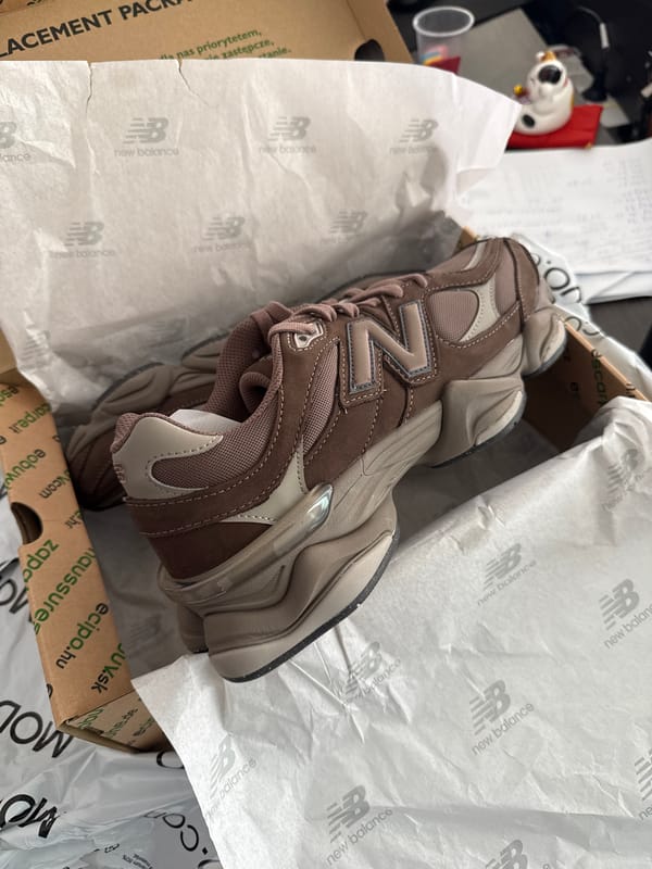 Brown New Balance 9060 sneakers documented in original packaging