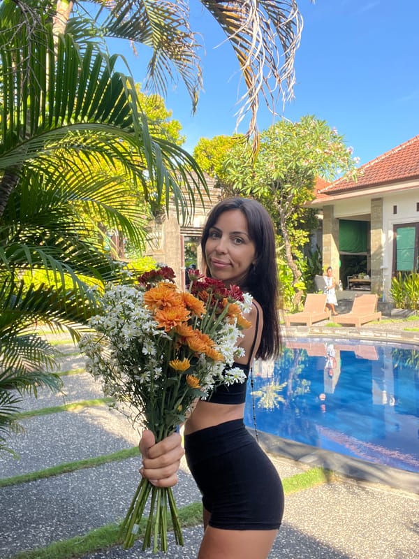 Woman poses with flowers during morning photoshoot in Kuta Selatan
