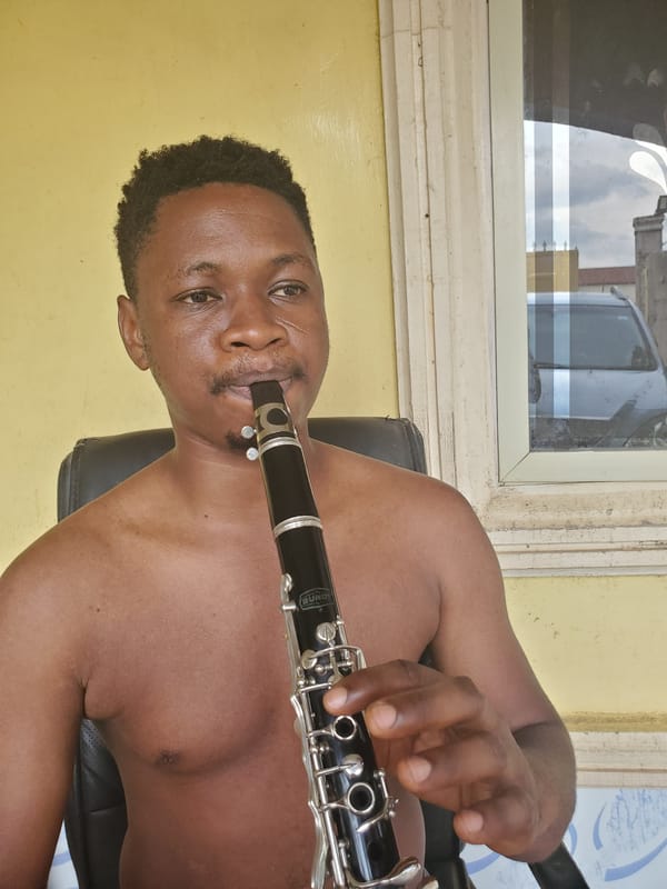 Man plays clarinet in Mararaba, Nigeria