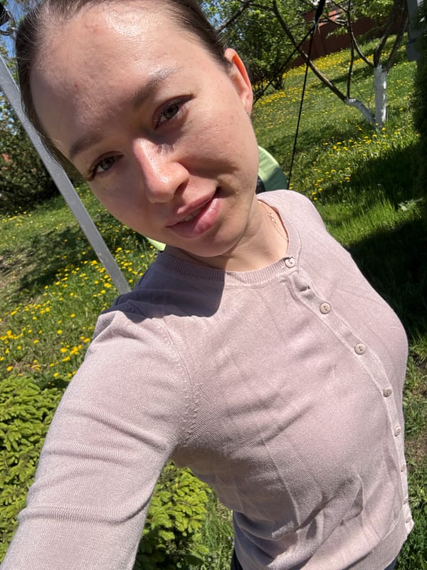 Woman, child enjoy spring morning in Russian village yard
