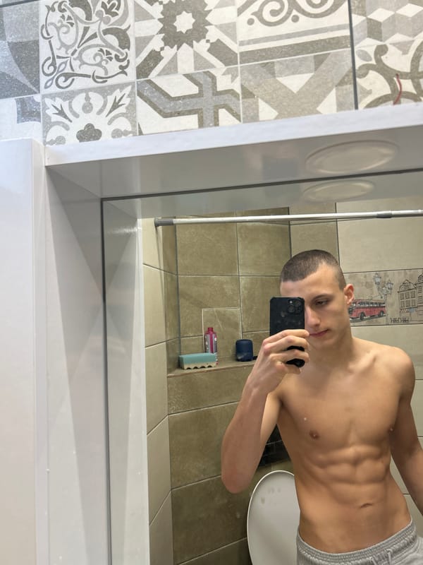 Young man takes bathroom mirror selfies in Burgas, Bulgaria