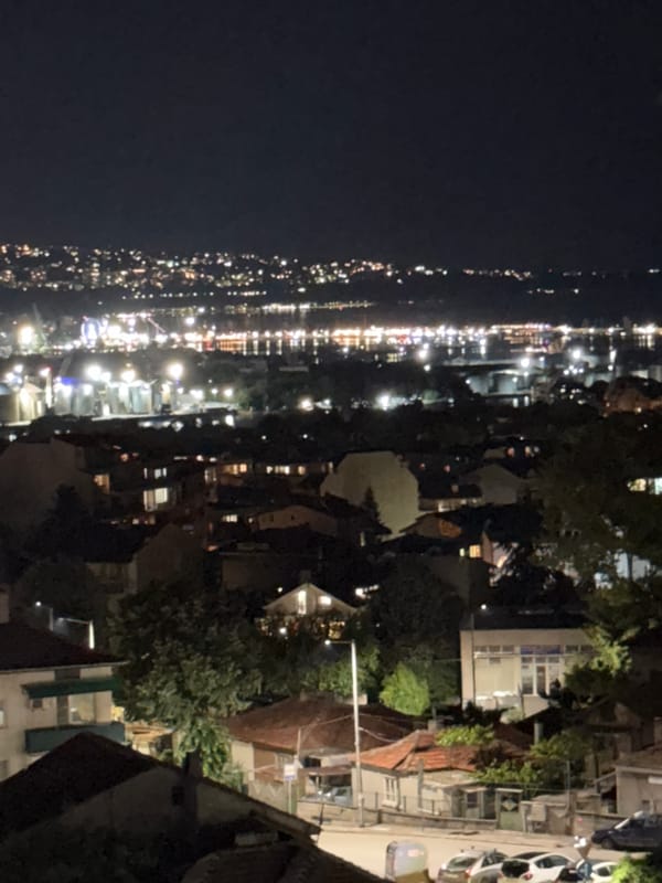 Evening balcony views of coastal city with personal moments