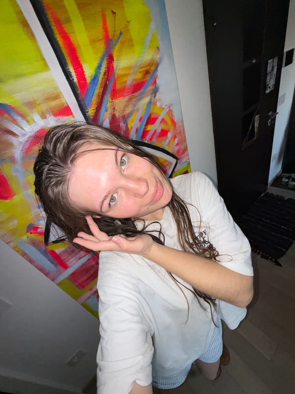 Woman photographed on painted floor, taking mirror selfie in Serbia