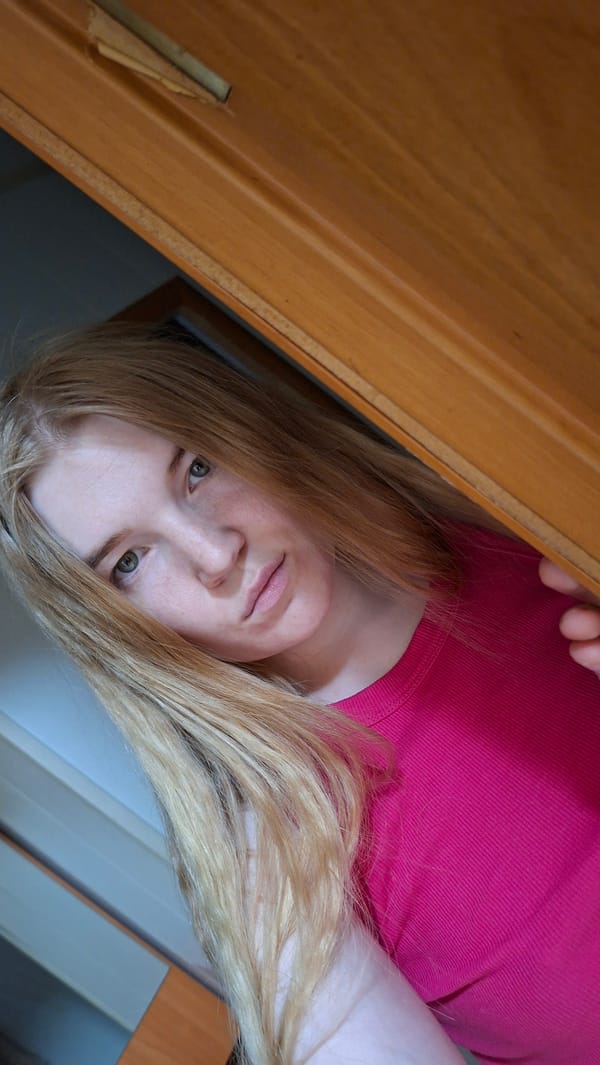 Young woman takes playful selfies indoors in rural Russia