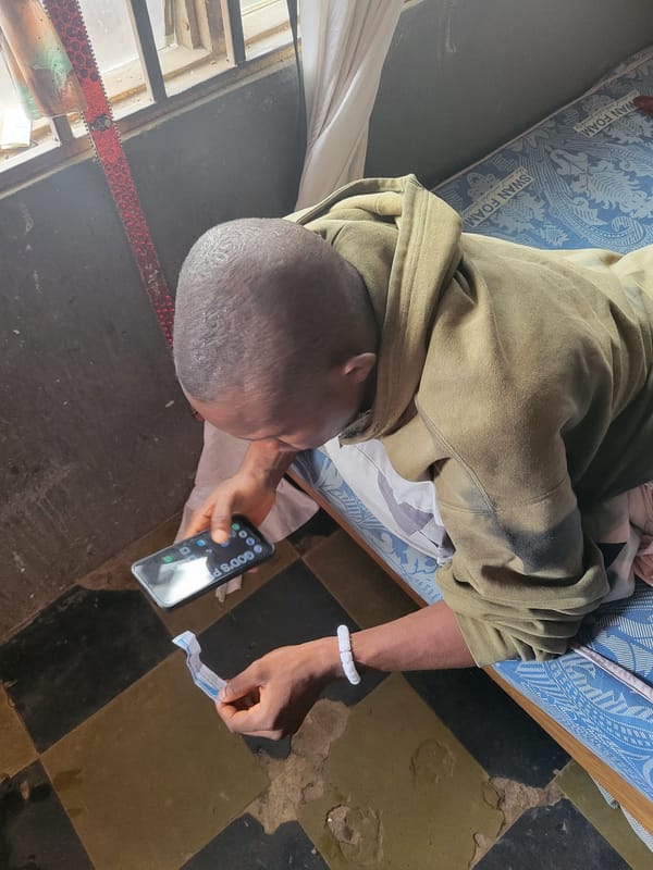 Man rests on mattress in Onitsha room