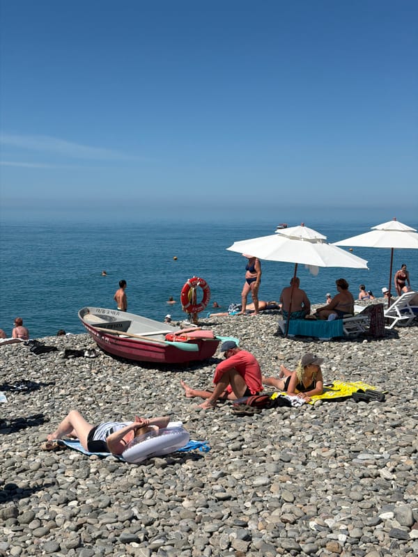 Crowded Black Sea beach in Sochi on a clear summer morning
