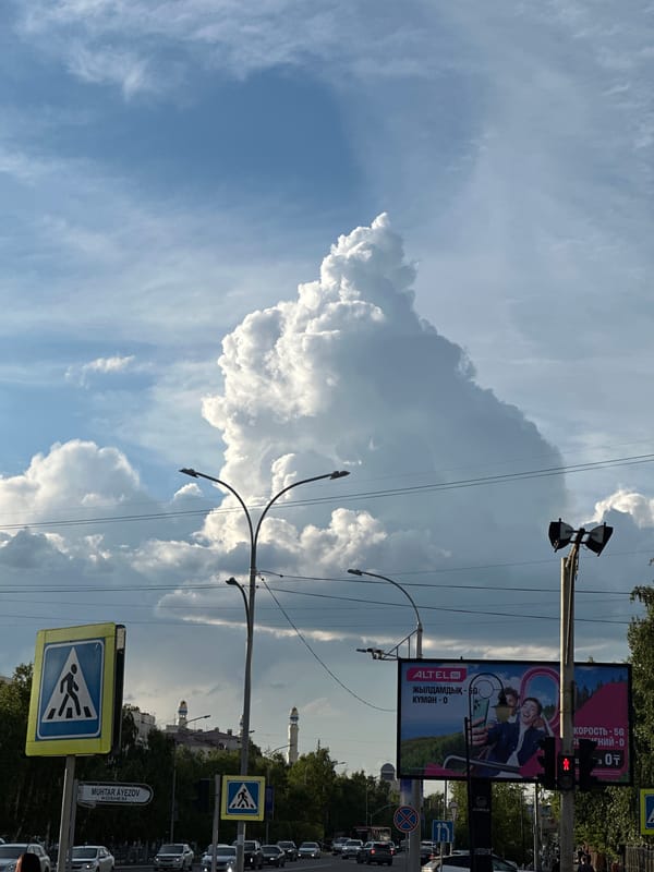 Street-level views of Kokshetau under a dramatic summer sky