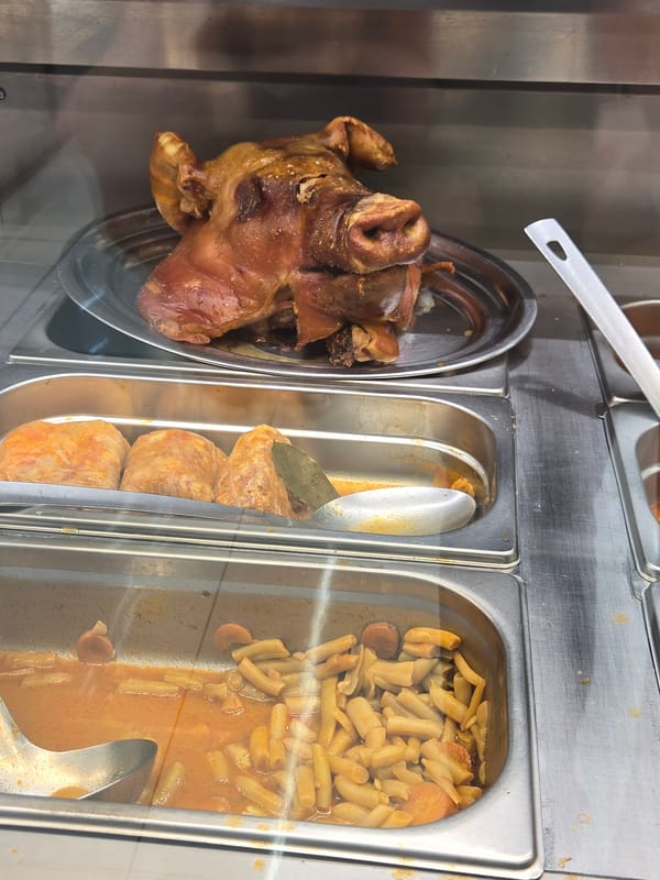 Buffet Display Features Cooked Pig's Head Among Food Items