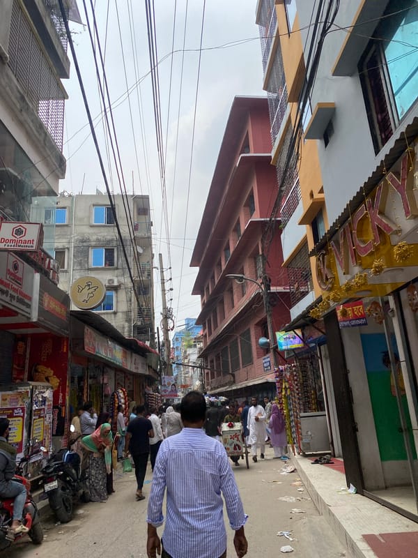 Morning street life: vendor, school children in Dhaka