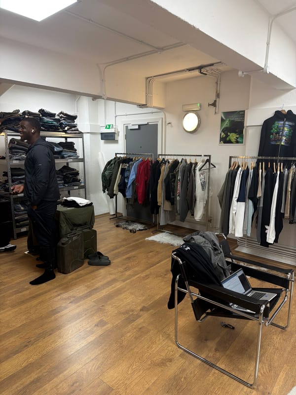 Two men browse London clothing store amid afternoon shopping
