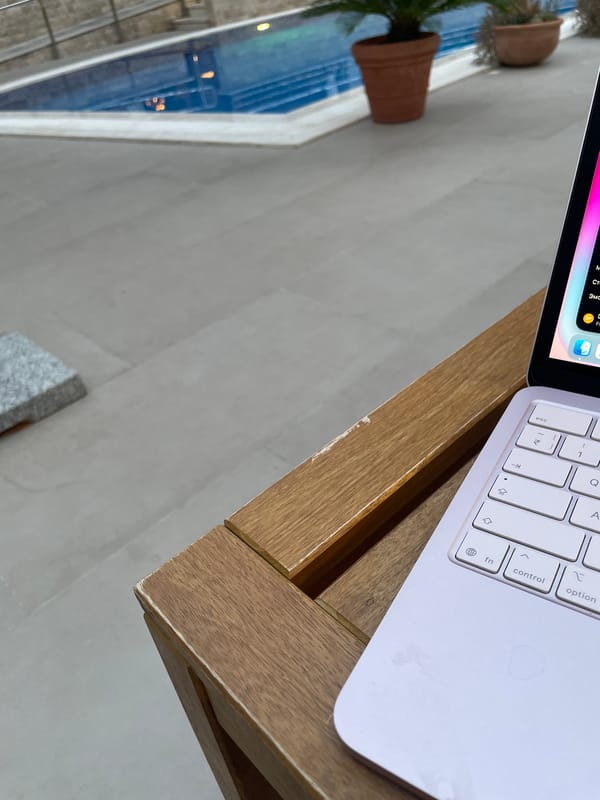 Café patron works on laptop at waterside Montenegro location