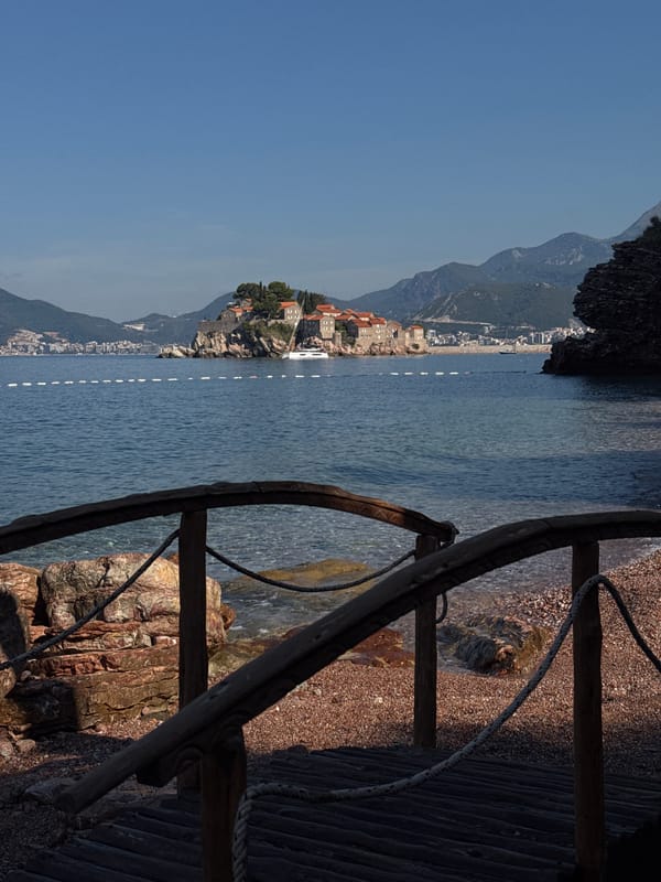 Sveti Stefan's fortified island viewed from a rustic walkway
