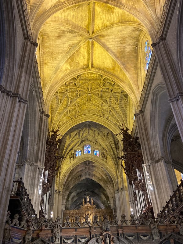 Visitor documents Seville Cathedral interior during restoration work